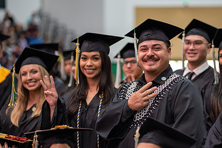 UOG graduates stand proudly during the University's Fanuchånan 2022