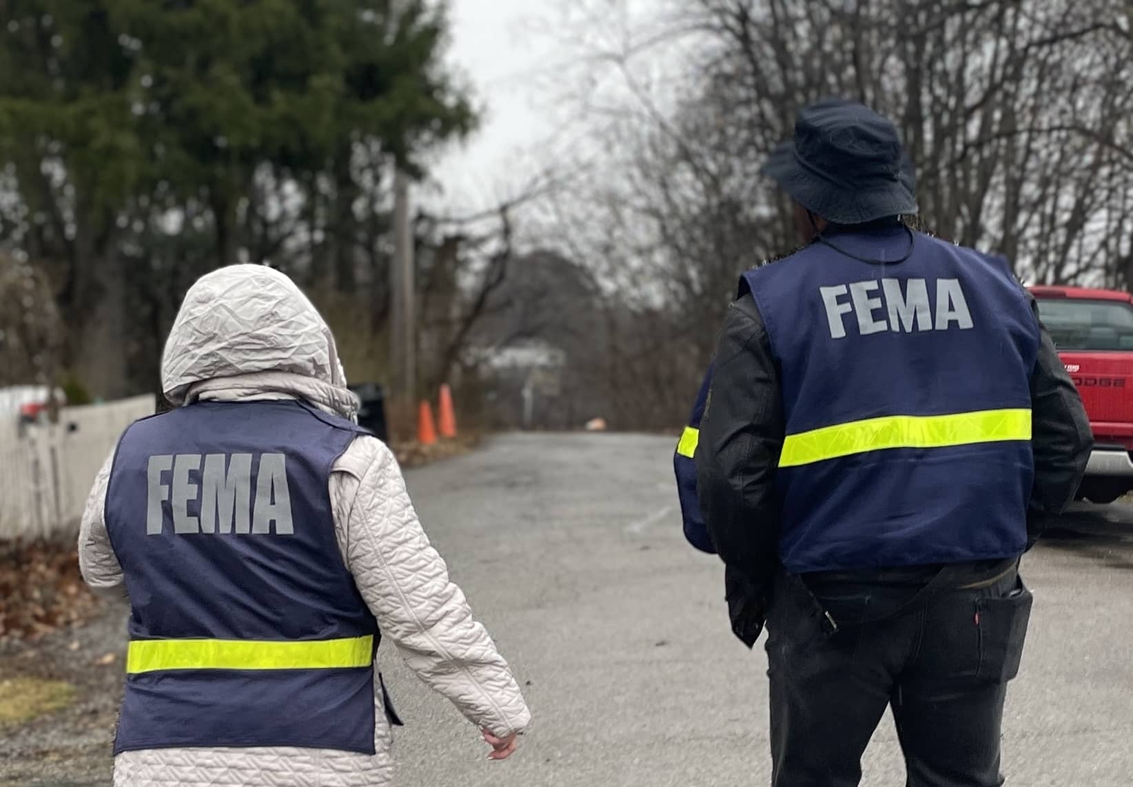 Two FEMA personnel walking during outreach