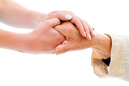 Photo of a person holding an elderly person's hand