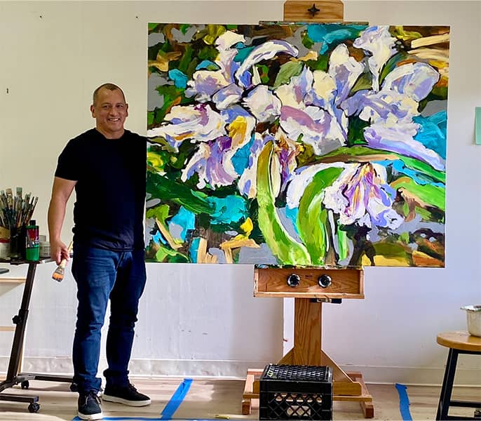 Ric R. Castro poses with his artwork.