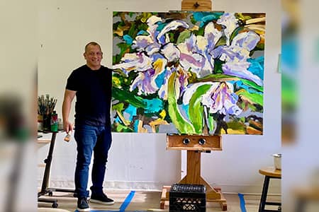 Ric R. Castro poses with his artwork.