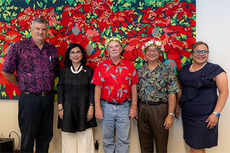 David S. Okada and James R. Hollyer pose with others at farewell gathering