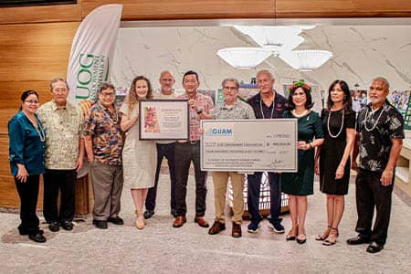 UOG President and members pose with UOG Endowment Foundation Members holding donation checks