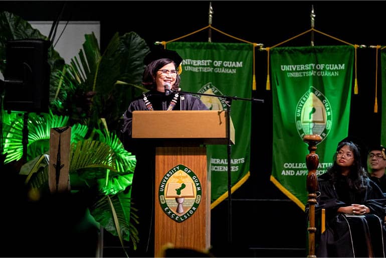 President Enriquez stands at a podium and speaks at her investiture