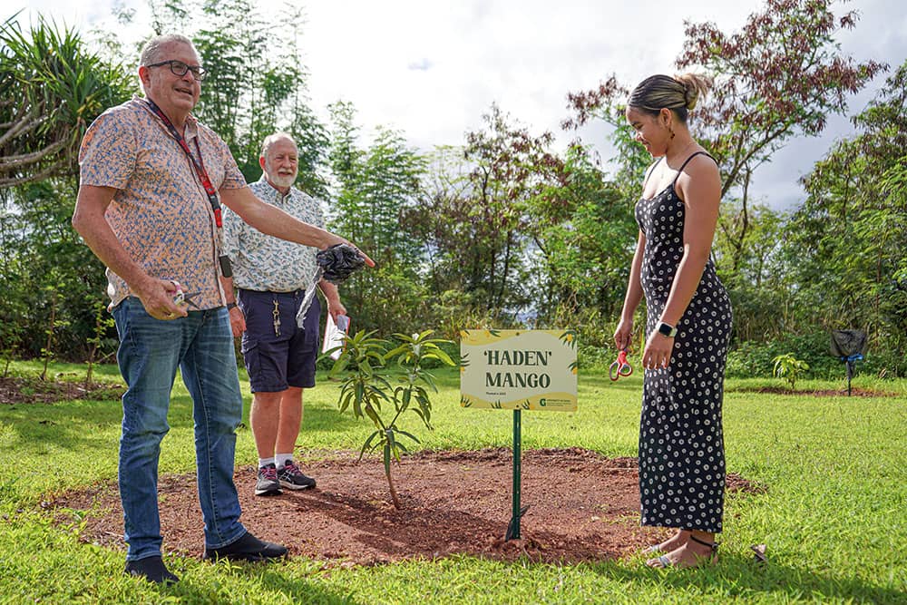 Photo of Lee Yudin and Kyona Rivera by newly planted mango tree