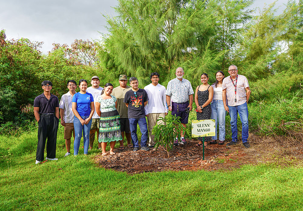 Group photo of agriculture students by newly planted Glenn mango tree