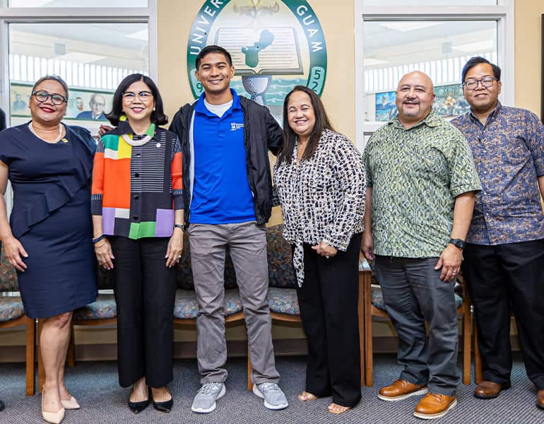 UOG Admin and Sen. Barnes pose with Ivan Blanco for a photo at awarding of Rotary Club Scholarship.