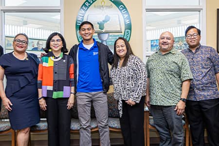 UOG Admin and Sen. Barnes pose with Ivan Blanco for a photo at awarding of Rotary Club Scholarship.