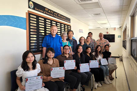 SEPRS scholarship recipients and members pose for a photo with awards