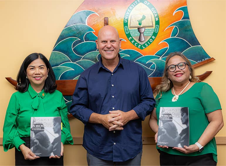 UOG President, Professor, and Senior Vice Provost pose for photo with new book
