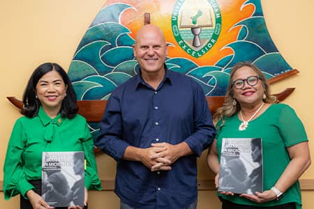 UOG President, Professor, and Senior Vice Provost pose for photo with new book