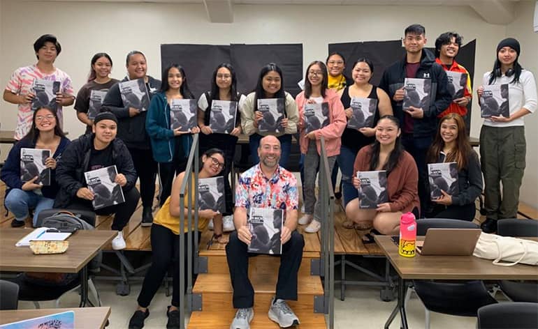 Dr. Dean Olah poses with new book and students of SOE