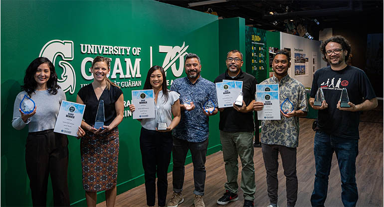 Members of UOG's marketing team pose for a photo at Guam Museum holding awards.