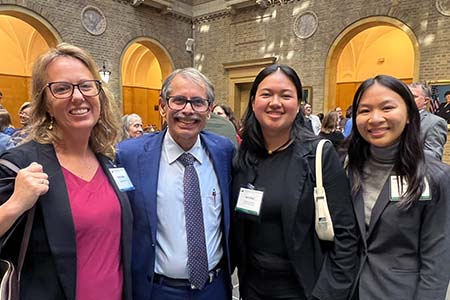 UOG agriculture majors Jamilee Cruz and Charlene Badajos with NIFA Director Manjit Misra. 