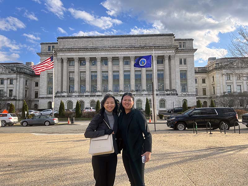 Photo of Charlene Badajos and Jamilee Cruz outside the USDA headquarters 