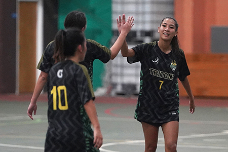 Lady Tritons team members giving each other a high five