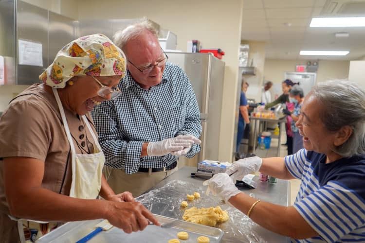 Participants share a laugh while learning to make whole-wheat rosketti.