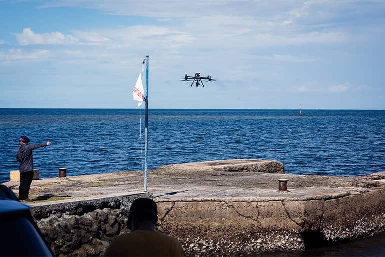 UOG drone corps member Kaya Taitano holds thumbs up to signal during drone launches