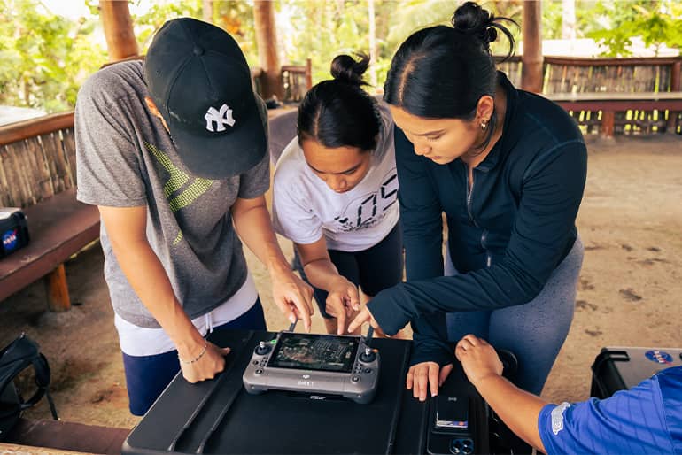 UOG students set up parameters for drone in Palau.