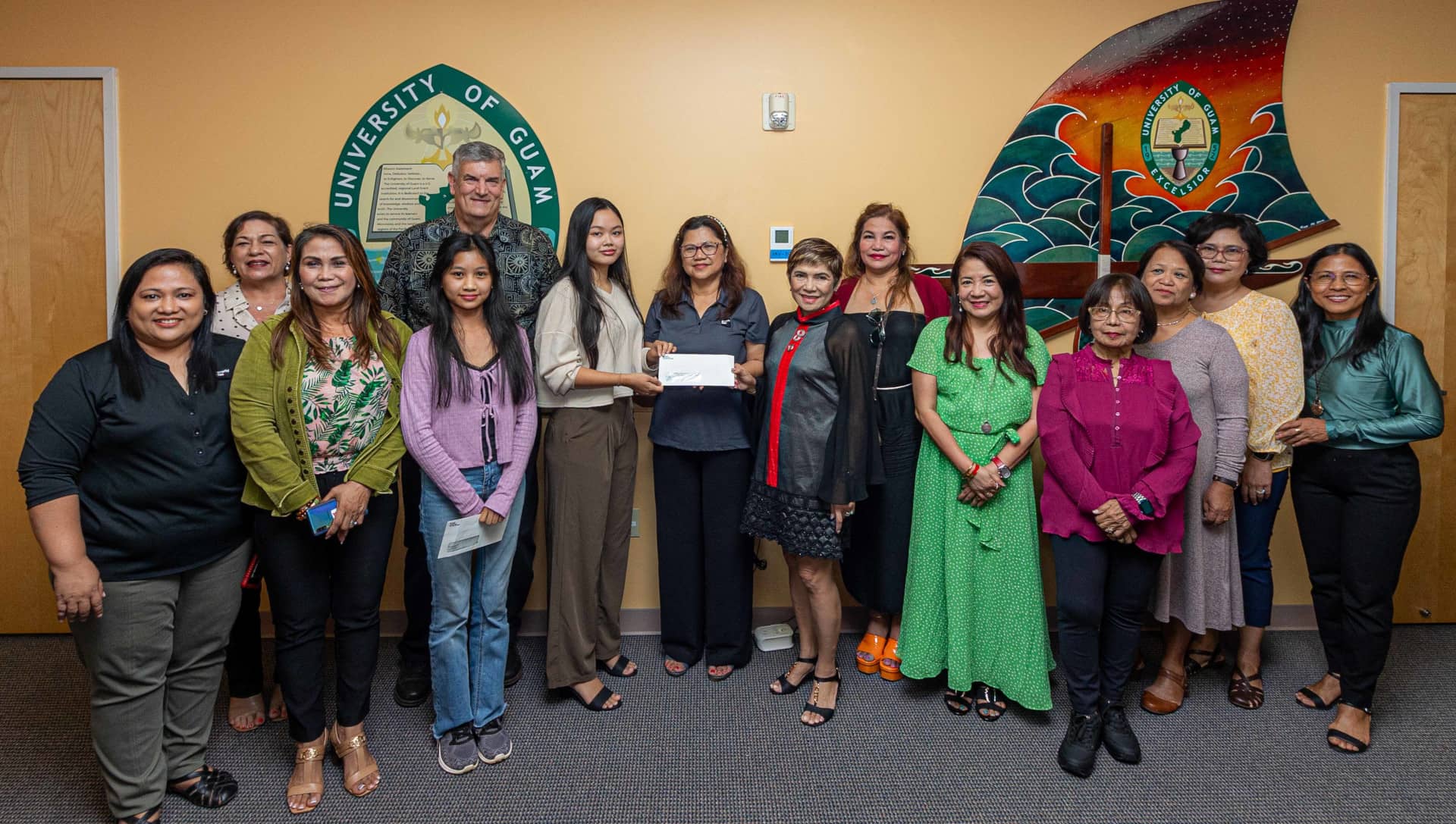 Filipino Ladies Association of Guam members and officers join University of Guam officials during the award of scholarships