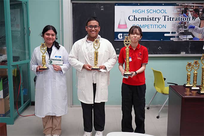 UOG Chemistry Titration Competition award winners Myka Imbat, Bernard Malicsi, Kaori Updegrove pose for a photo