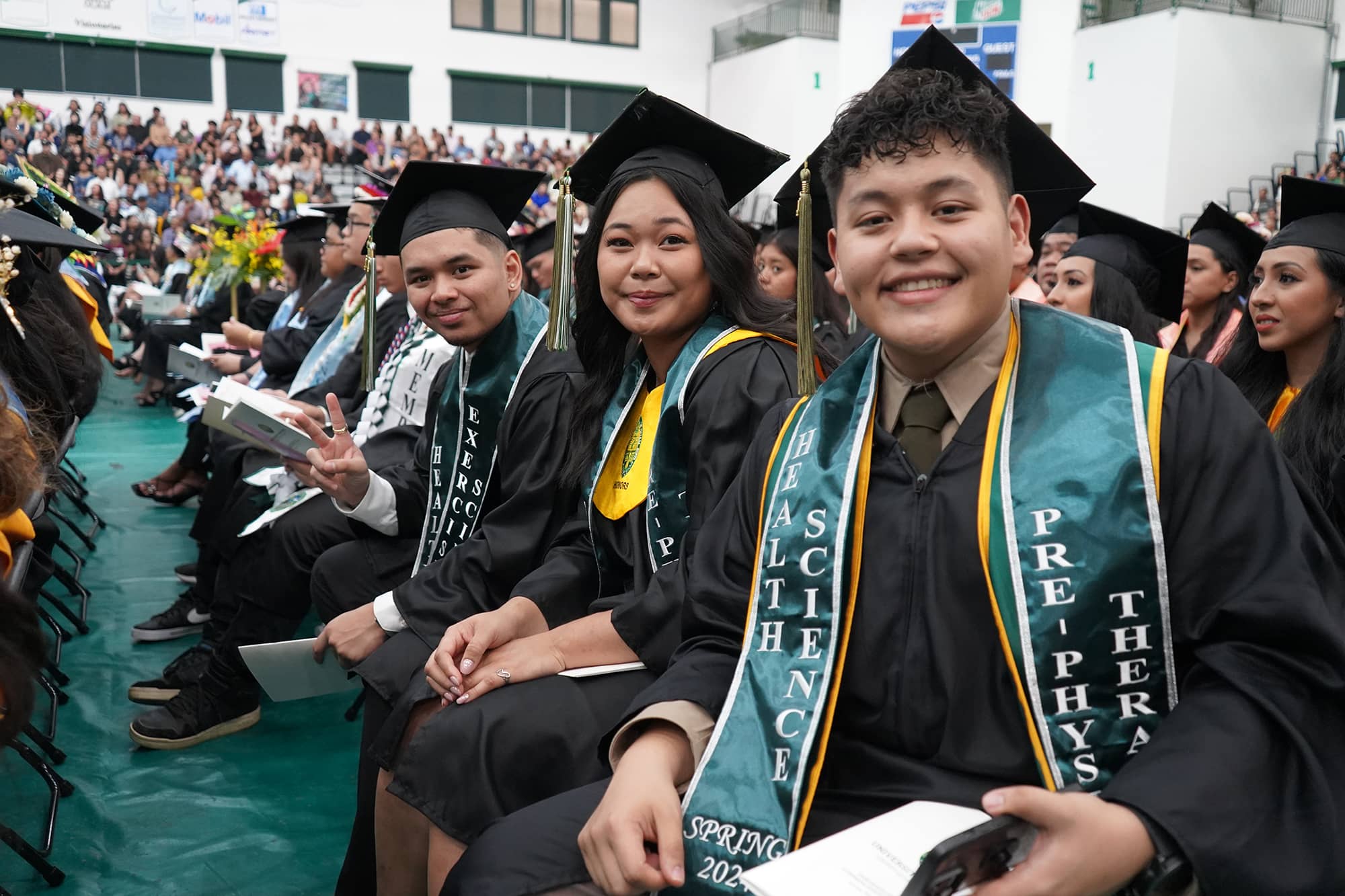 President Anita Borja Enriquez applauds the 319 graduates from the commencement stage.