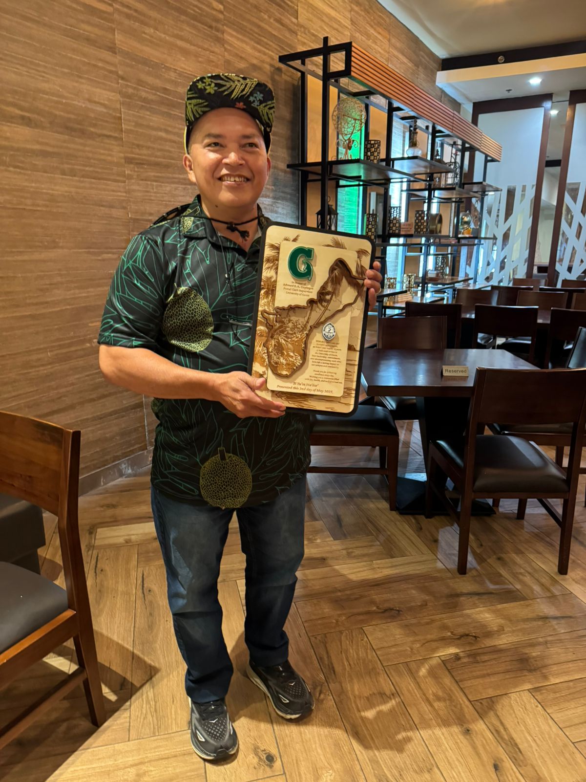 Edward Unpingco holding plaque 