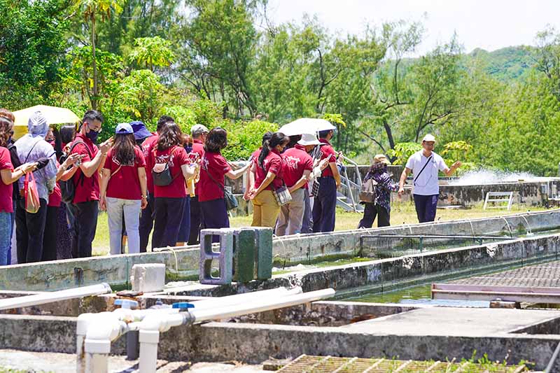 Photo of a group touring an aquaculture facility