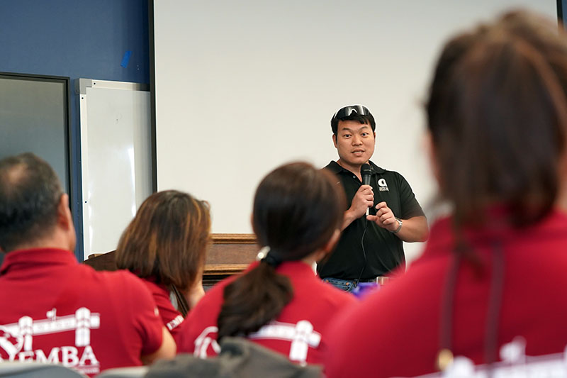 Faculty member speaking into a microphone