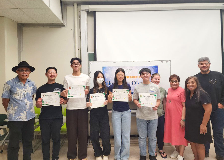 Group of students holding certficates alongside teachers