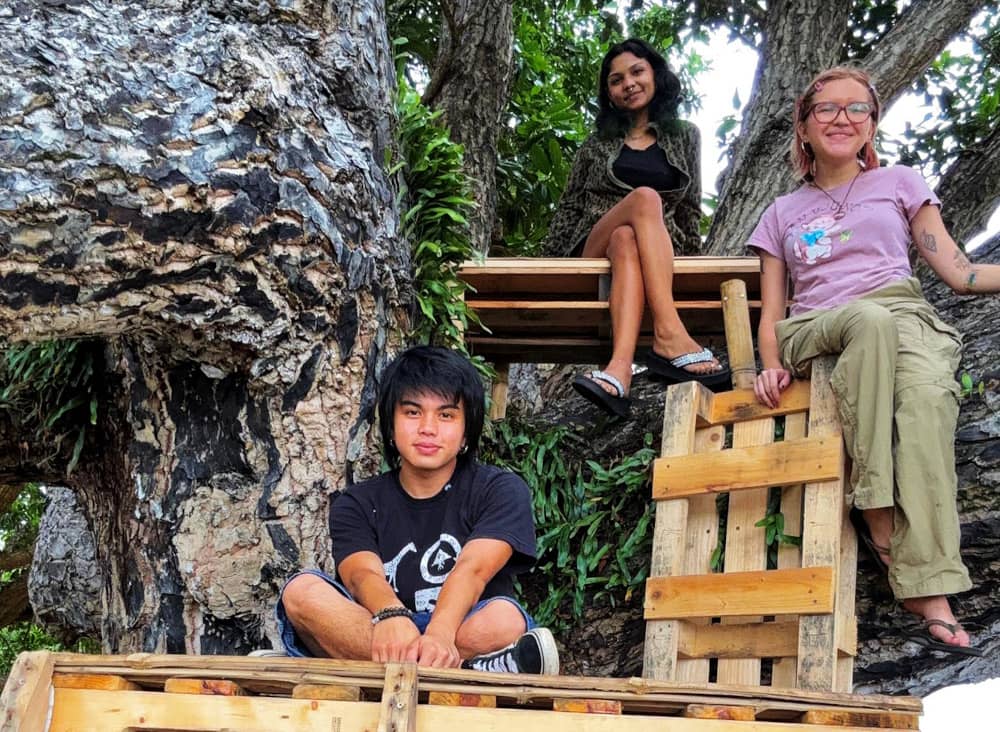 From concept to construction, this student-led project brought together artists from across class levels and majors. In this photo: Maria Sol Marques (right), Kai Chaco (left), are joined by a friend to showcase the art installation. 