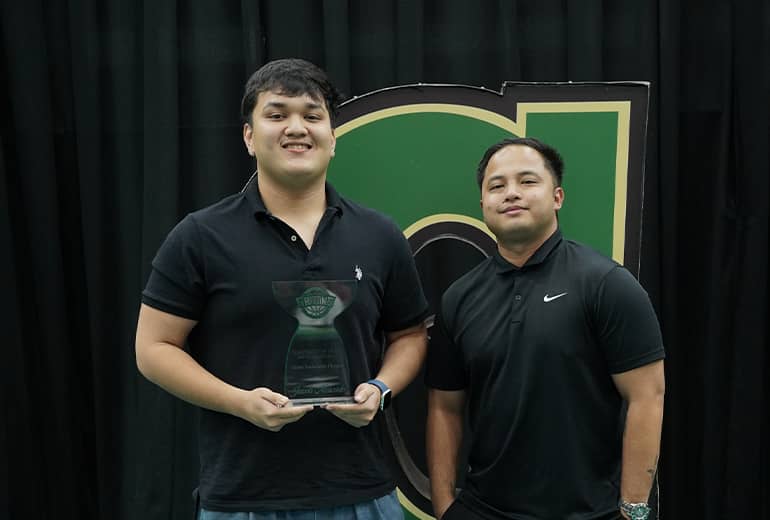 Jacob Mercado and Argie Flores pose for photo with trophy and Triton G sign