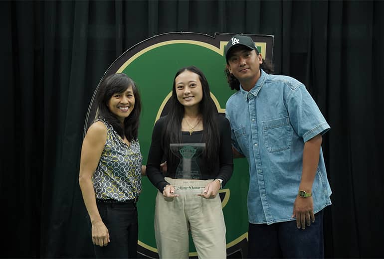 Maria Duenas, Cil Olandez, and Timothy Edillor pose for photo with trophy and Triton G sign