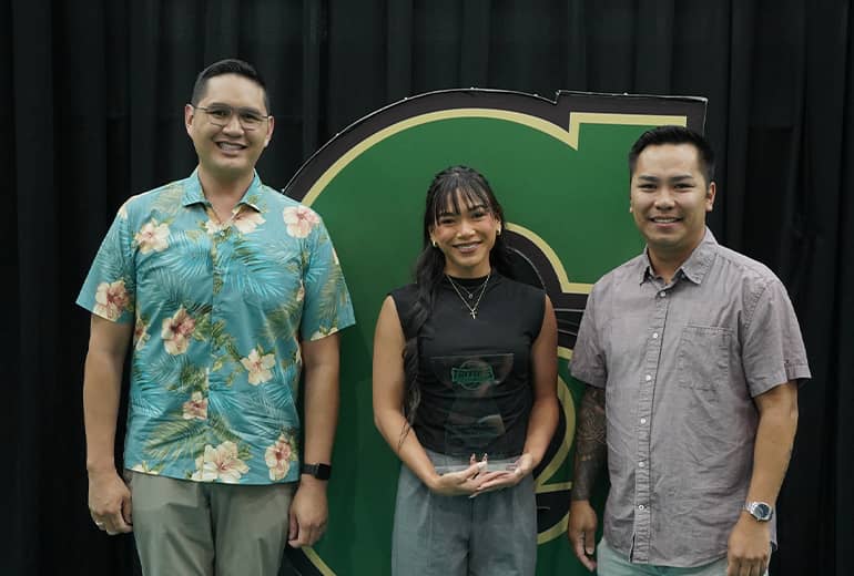 Tehya Mendiola, Joey Tedpahogo, and Greg Cruz pose for photo with trophy and Triton G sign