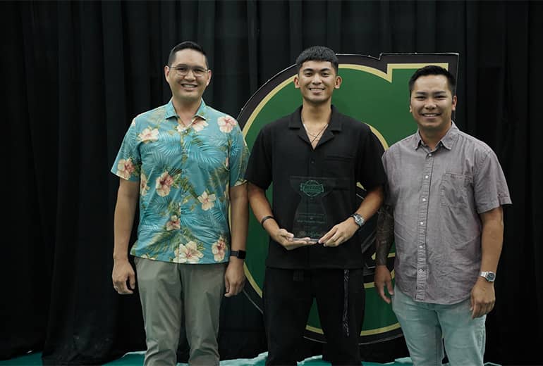 Joe Mafnas, Joey Tedpahogo, and Greg Cruz pose for photo with trophy and Triton G sign