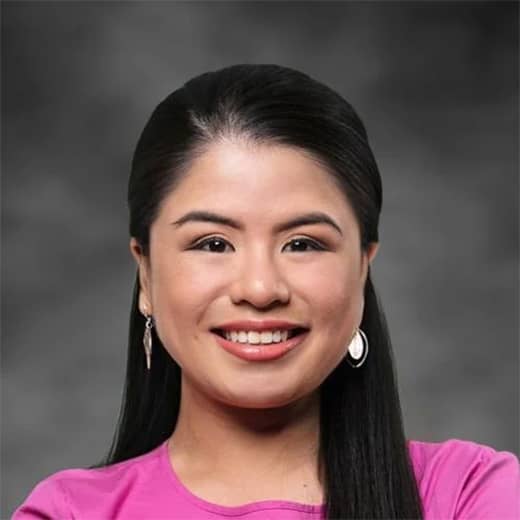 Trixie Naholowaa-Torres portrait photo in front of gray elemental background