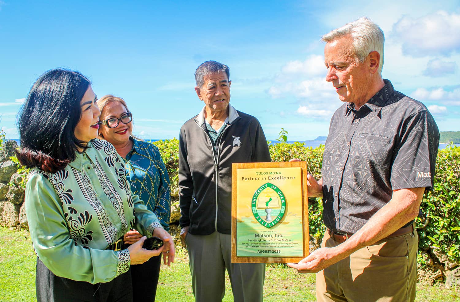  UOG President Anita Borja Enriquez presents the Tulos Mo’na Partner in Excellence plaque to Matson Chairman and CEO Matt Cox