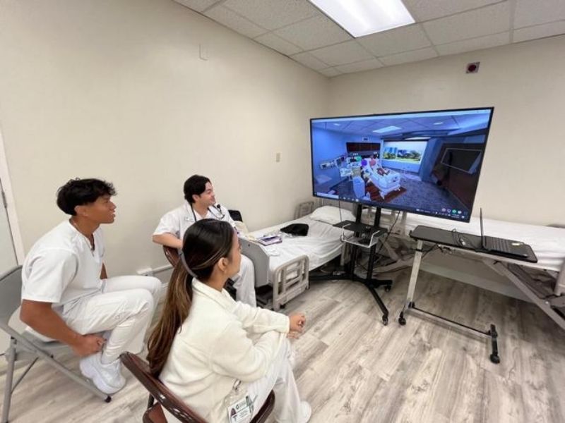 UOG nursing students observe a virtual patient scenario.