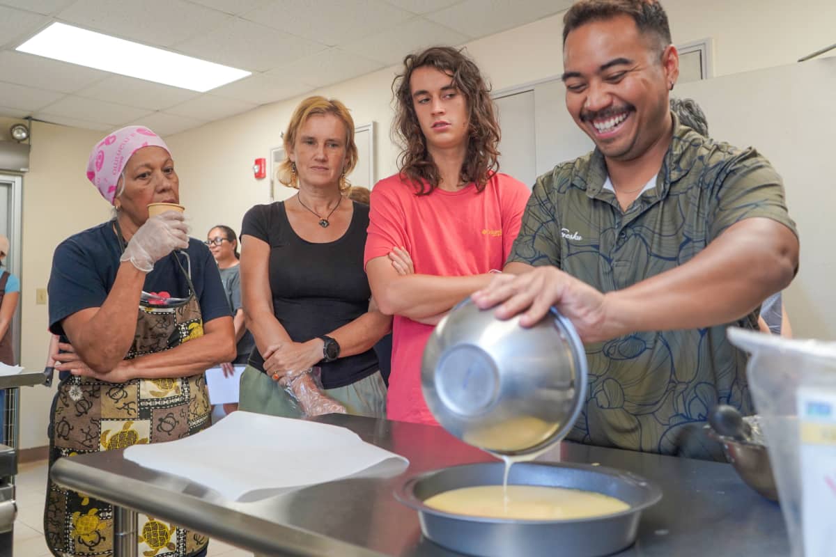 Jonah Babauta pours batter into a pan.