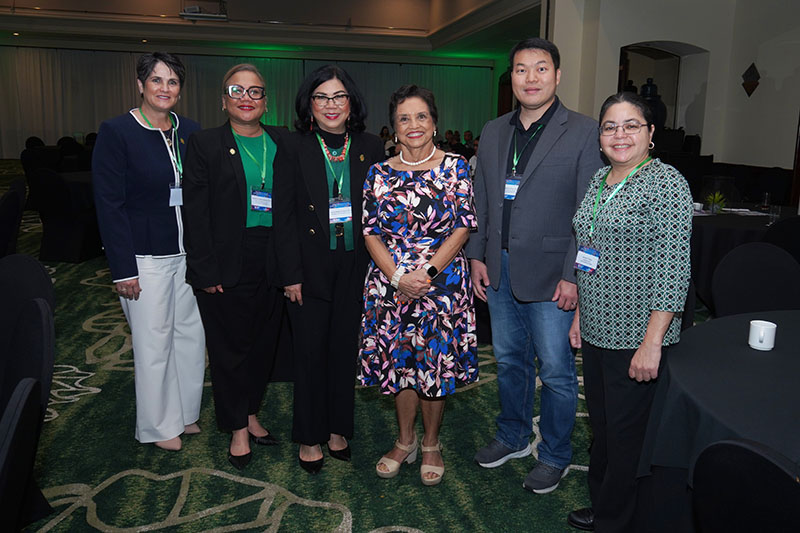 The governor of Guam standing with UOG administrators in the Hyatt ballroom 