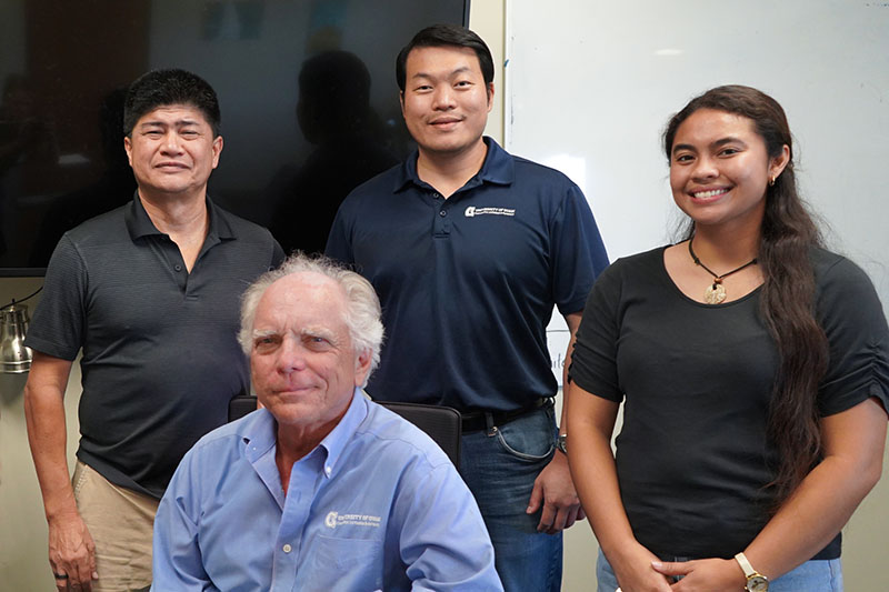 A posed photo of 4 reseearchers in a conference room