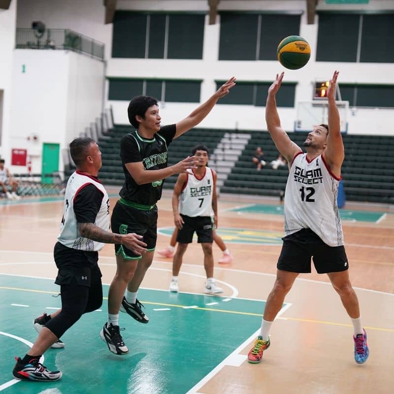 Guam Nationals surround a Triton player. 