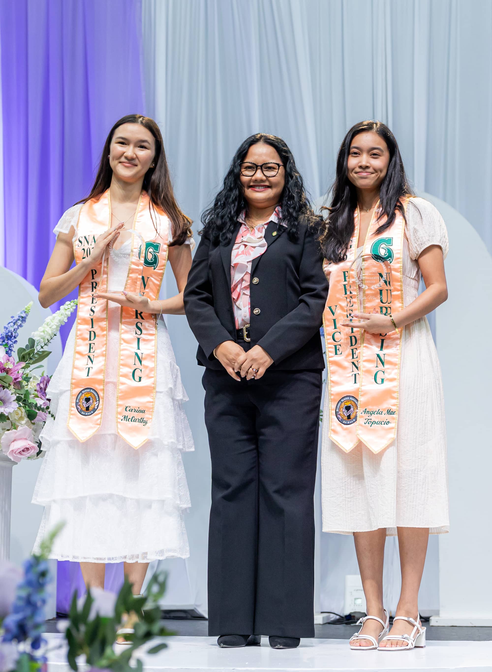arina McCarthy, left, and Angela Topacio, right, pose with Dr. Yvette Paulino