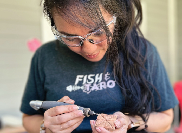 University of Guam alumna Sarah Taitano blends art, culture, and care through More Art x Less War, a Pacific Islander lifestyle brand rooted in mixed media, indigenous identity, and social justice. Drawing from her background in social work and mental health advocacy, Taitano uses creativity as a form of healing, connection, and purposeful change.