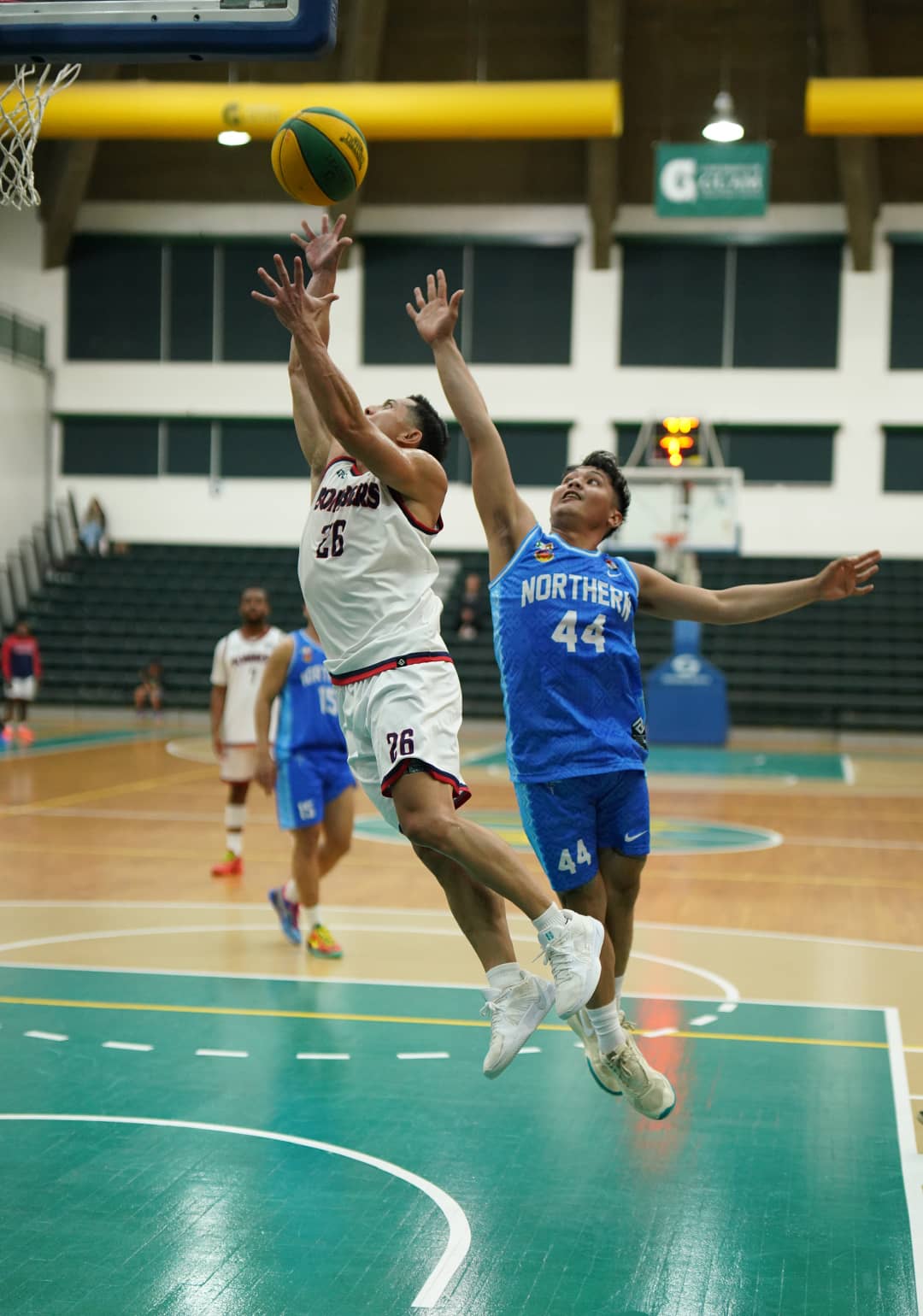 Number 26 and Number 44 contest a rebound