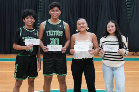Triton Athletics awards Gage Johnson scholarships to four UOG basketball players.
