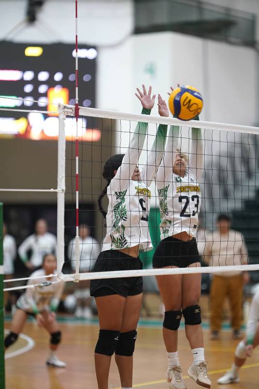 Lady Tritons is about to serve.