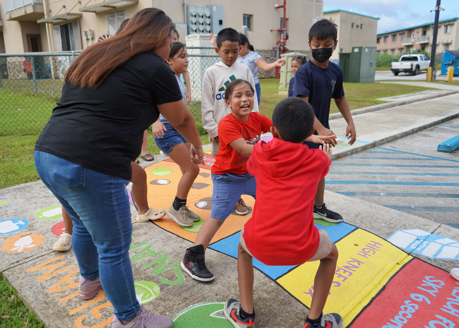 Kids playing while adults watch