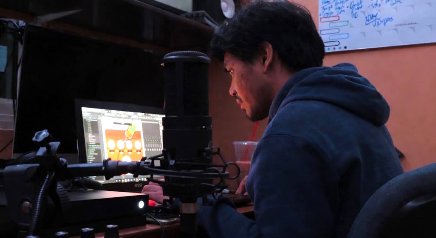 Emann Adonay works on a track in his music studio