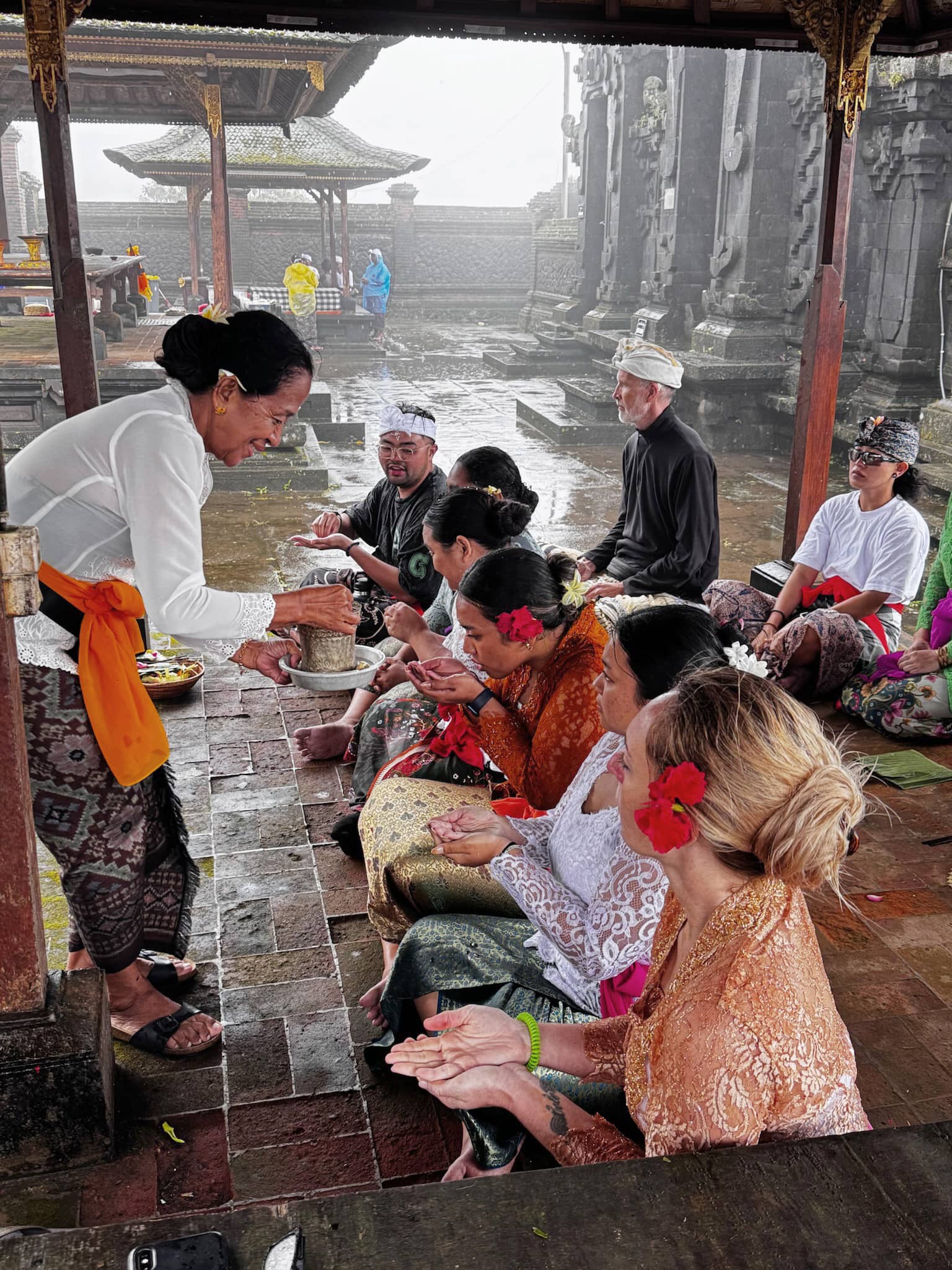matriarch blesses students with holy water and rice